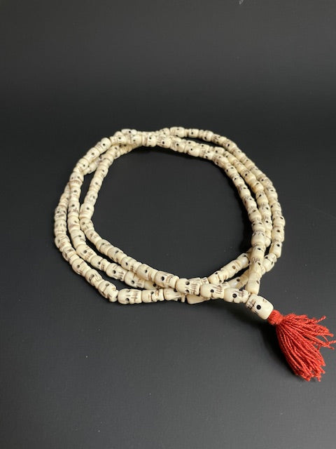 Very long yak bone necklace with skulls - white